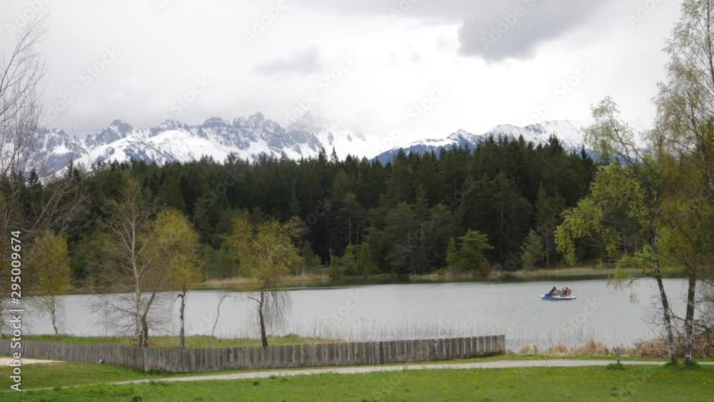 Alpine Austrian landscape with lake and mountains in the background Alpine Austrian landscape with lake and mountains in the background