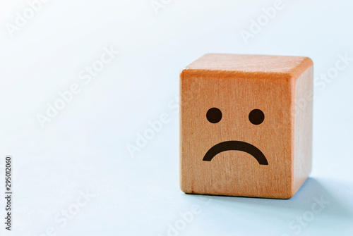 Small wooden dice with sad emotion