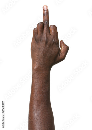 Hand of African-American man showing middle finger on white background photo