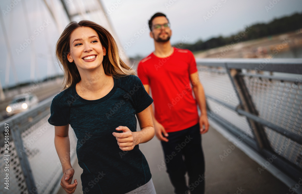 Obraz premium Healthy sporty young people jogging and running outdoors