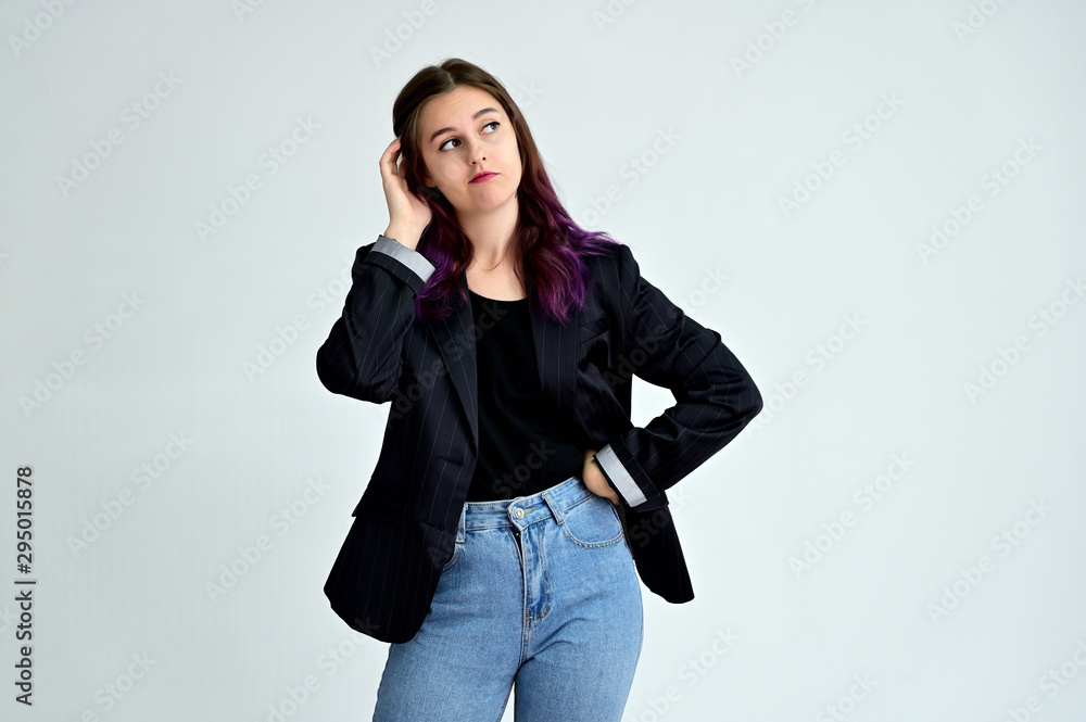 Studio portrait of a pretty brunette student girl with long hair in a jacket on a white background. Smiling at camera with emotions in various poses. Studio portrait of a pretty brunette student girl with long hair in a jacket on a white background. Smiling at camera with emotions in various poses.