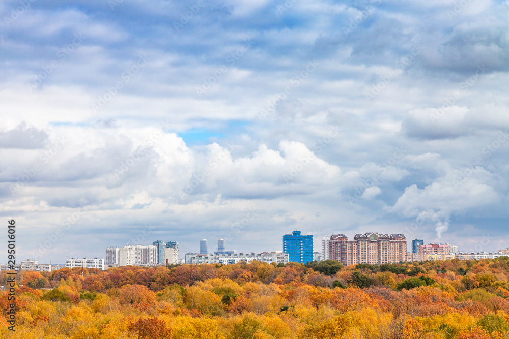 large white clouds in blue sky over yellow park