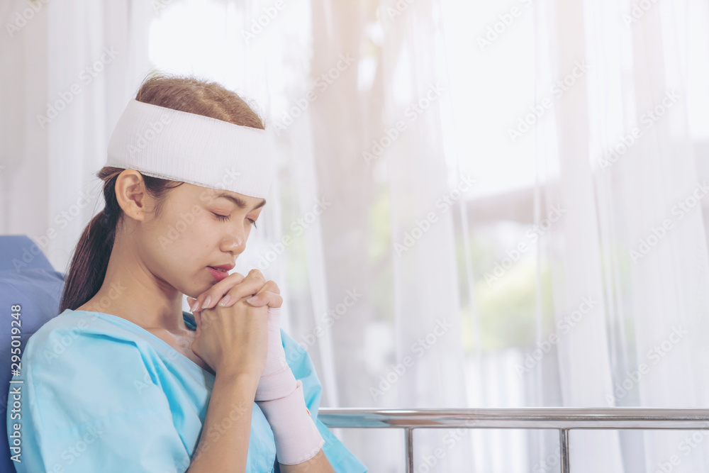 Lonely accident patients injury woman on Patient's bed in hospital want to go home - medical concept Lonely accident patients injury woman on Patient's bed in hospital want to go home - medical concept