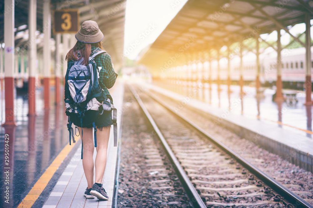 Asian girl with a backpack traveling alone at the train station.,