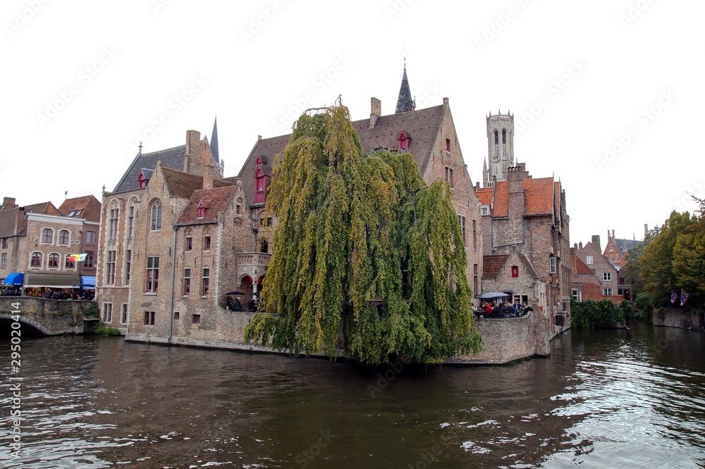 The Rozenhoedkaai canal, historical brick houses and the Belfry in Bruges medieval Old Town in autumn in Bruges (Brugge), Belgium