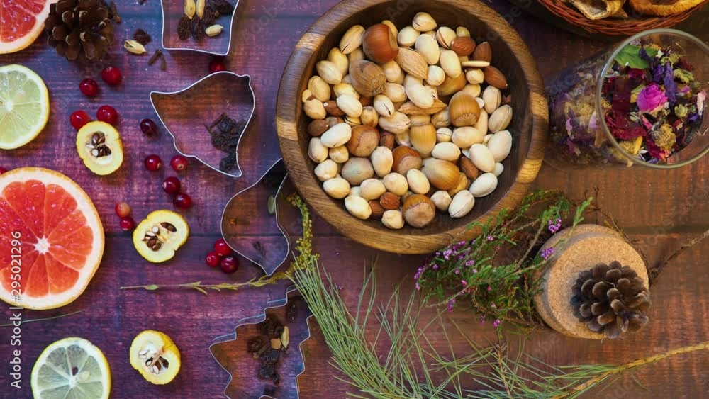 Christmas background of nuts, dried apples, fresh grapefruit, lemon, cydonia slices, spices, raisin, berries, mixed herb tea, cone, branch, baking dish. Ingredients for Christmas Baking Christmas background of nuts, dried apples, fresh grapefruit, lemon, cydonia slices, spices, raisin, berries, mixed herb tea, cone, branch, baking dish. Ingredients for Christmas Baking