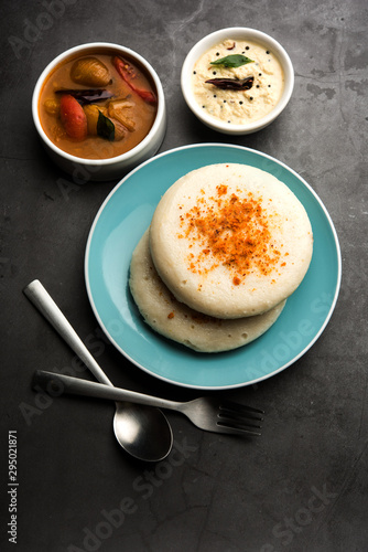 Thatte or Taste Idli also known as Plate Idly is a Popular south Indian Food, served with sambar and chutney.  photo