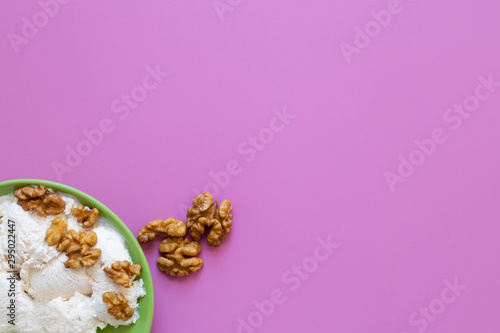 Ice cream with walnut, pink background.