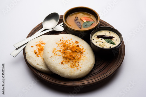 Thatte or Taste Idli also known as Plate Idly is a Popular south Indian Food, served with sambar and chutney.  photo