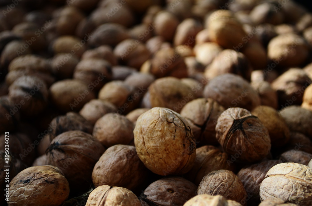 Natural walnut background pattern texture Abstract walnuts heap pattern background Blurred edges frame Natural food in-shell nuts walnuts