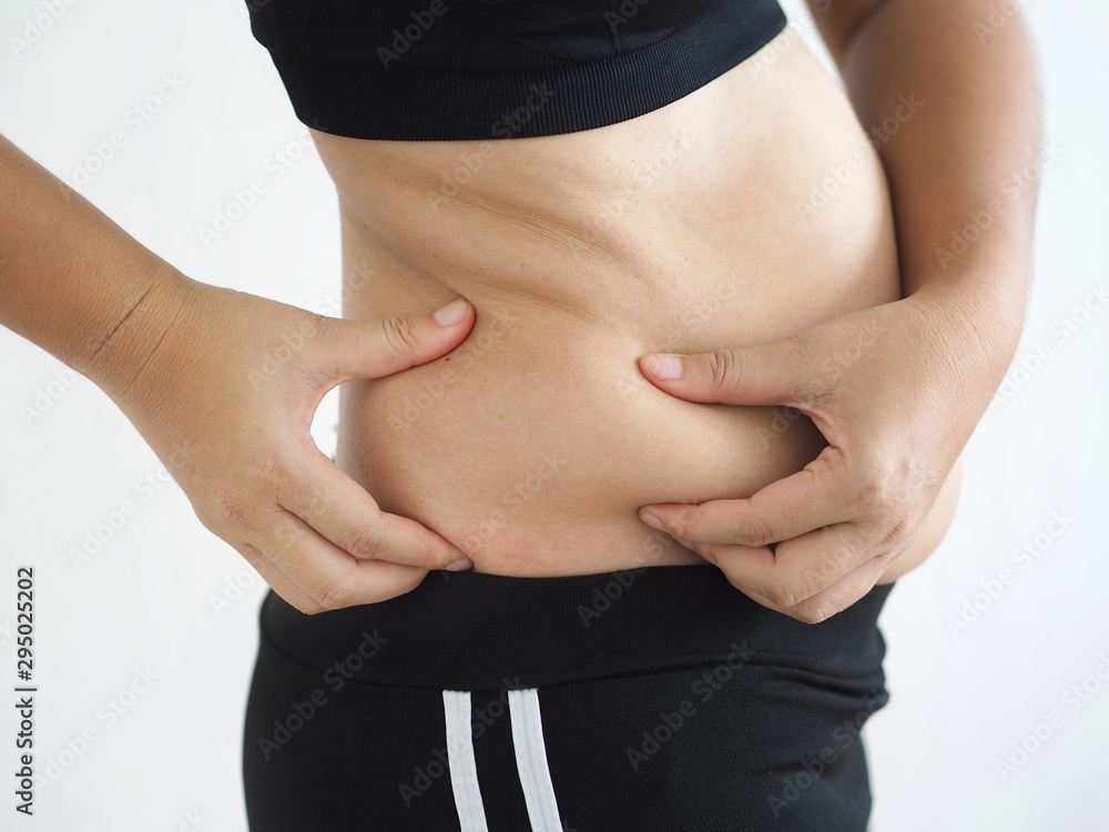 Φωτογραφία cellulite and belly fat in woman, She grabbing her abdomen near waist cause of fatty from weight and loss of collagen use for body firming gel,cream product or liposuction concept
