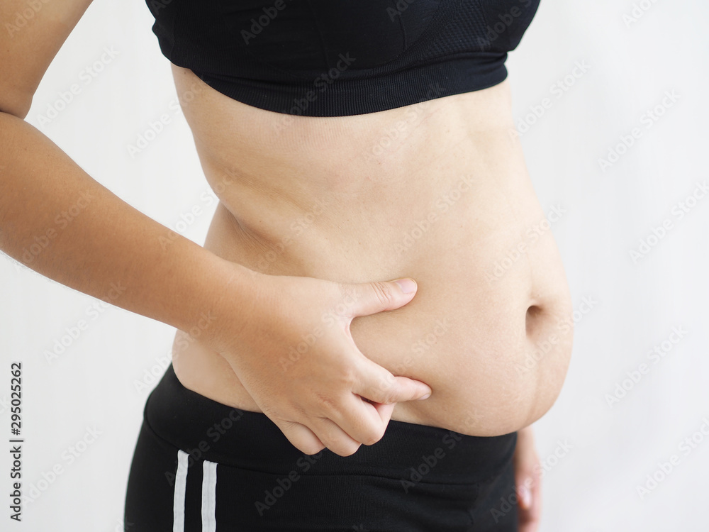 Φωτογραφία cellulite and belly fat in woman, She grabbing her abdomen near waist cause of fatty from weight and loss of collagen use for body firming gel,cream product or liposuction concept