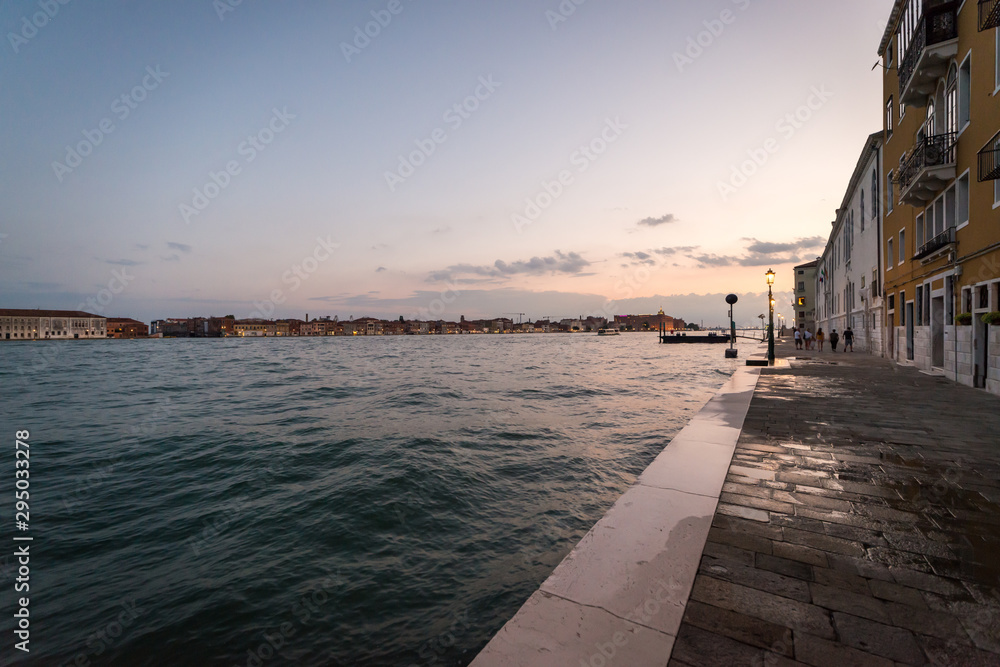 Wide angle view of the Giudecca Canal in Venice, Italy in the early evening light