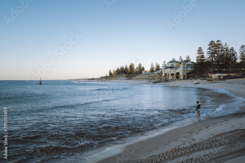 An empty and calm Cottesloe beach at sunrise. Peaceful morning as the sun rises over the city. 