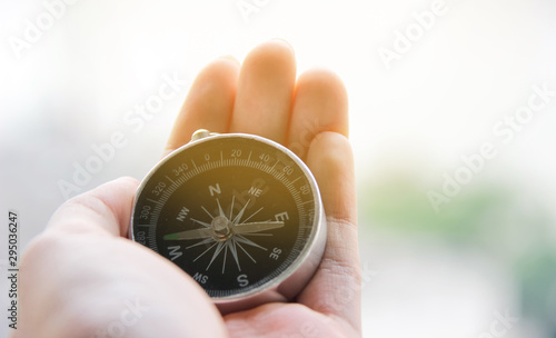 Hand holding a compass to guide the way, Compass business navigate, navigation of life photo