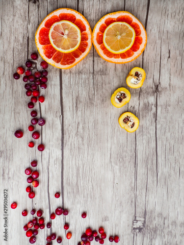 grapefruits, lemon, cydonia slices, red cranberries, top view. Natural vitamins and antioxidants food concept.