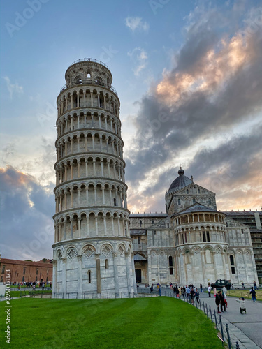PISA, ITALY - SEPTEMBER 27, 2019: Field of Miracles at sunsetwith tourists