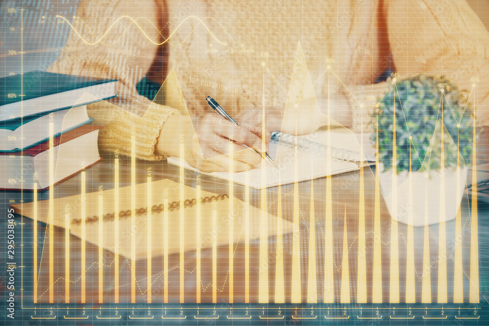 Forex graph on hand taking notes background. Concept of research. Double exposure Forex graph on hand taking notes background. Concept of research. Double exposure
