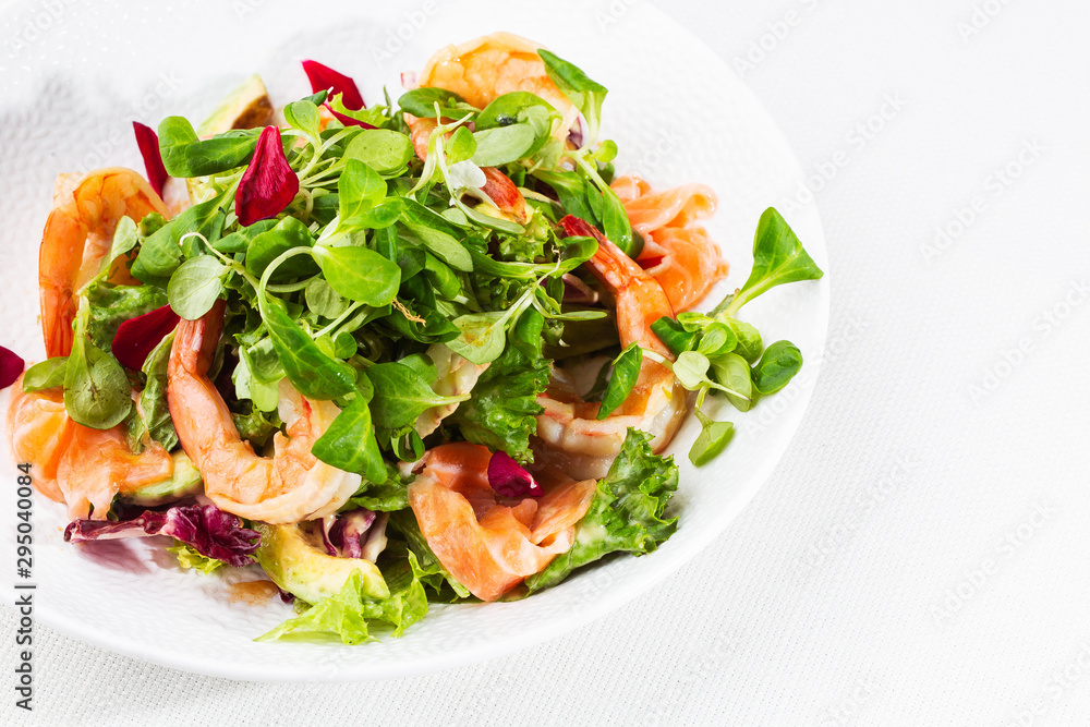 Healthy Salad. Recipe for fresh seafood. Grilled shrimps, prawns, fresh salad lettuce and avocado slices. Healthy Eating. White background. Horizontal photo. Healthy Salad. Recipe for fresh seafood. Grilled shrimps, prawns, fresh salad lettuce and avocado slices. Healthy Eating. White background. Horizontal photo.