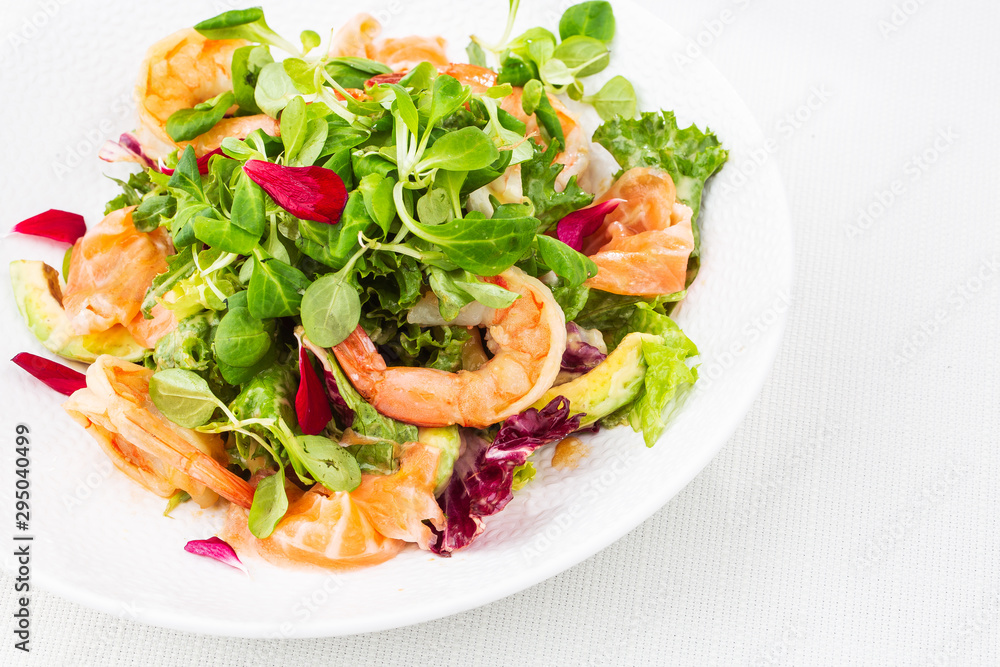 Healthy Salad. Recipe for fresh seafood. Grilled shrimps, prawns, fresh salad lettuce and avocado slices. Healthy Eating. White background. Horizontal photo. Healthy Salad. Recipe for fresh seafood. Grilled shrimps, prawns, fresh salad lettuce and avocado slices. Healthy Eating. White background. Horizontal photo.