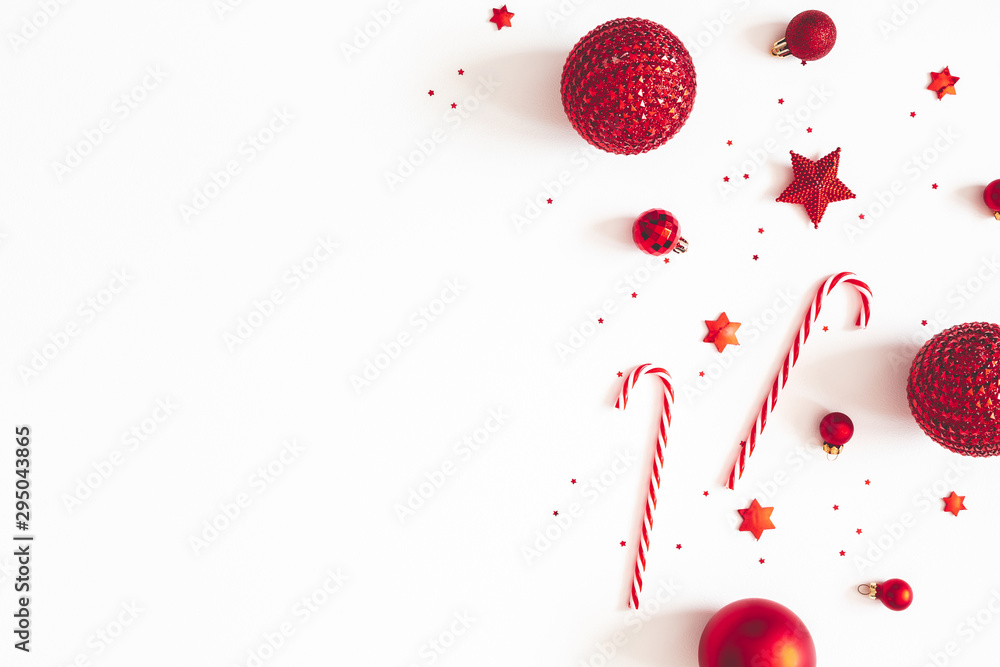 Christmas composition. Red decorations on white background. Christmas, winter, new year concept. Flat lay, top view, copy space - obrazy, fototapety, plakaty 