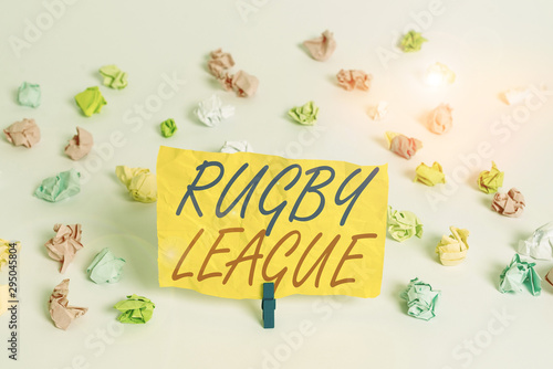 Word writing text Rugby League. Business photo showcasing form of rugby football played between teams of 13 players Colored crumpled papers empty reminder white floor background clothespin