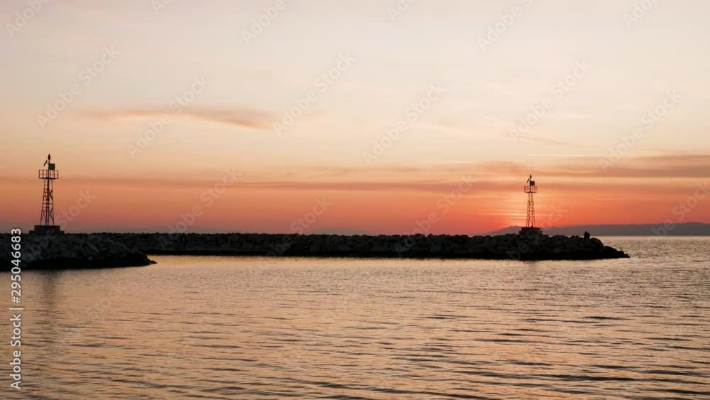 Silhouette of lighthouses on beautifl orange sunset. End os summer vacation.