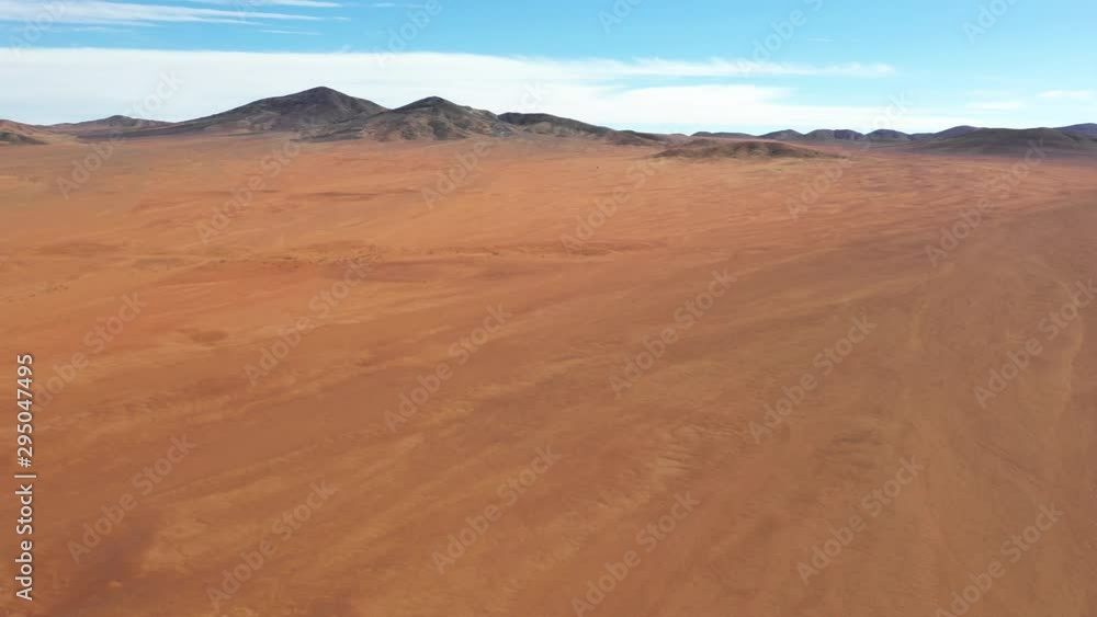 Exploring Atacama Desert vast dry extensions in the driest area of this amazing desert with an all terrain vehicle. An awe road trip adventure crossing the infinite sand extensions from an aerial view Exploring Atacama Desert vast dry extensions in the driest area of this amazing desert with an all terrain vehicle. An awe road trip adventure crossing the infinite sand extensions from an aerial view