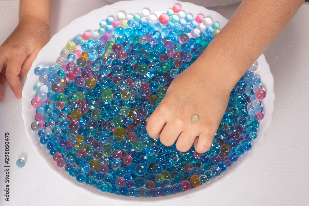 Playing with water bead orbees. Kid playing with sensory water bead
