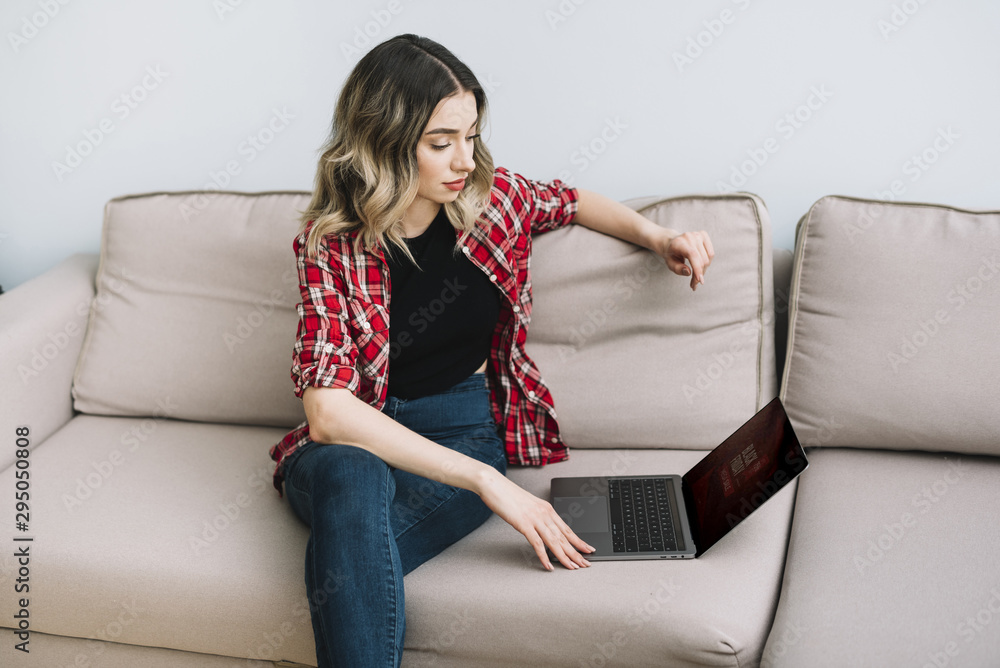 Woman at home looking on laptop Woman at home looking on laptop