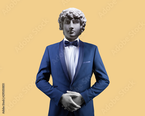 Modern art collage. Concept portrait of handsome stylish man in elegant blue suit .Gypsum head of of Antinous. Man in suit. photo