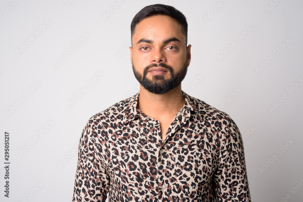 Obraz premium Face of young handsome bearded Indian man