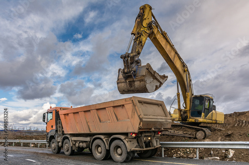 Excavator loading a truck at construction sites