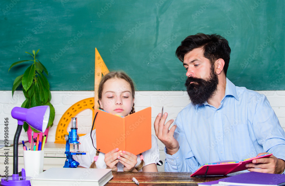 Naklejka premium Man bearded teacher excellent pedagogue. Pedagogue skills. Talented pedagogue. Work together to accomplish more. Explaining science to child. Fascinating lesson. School teacher and schoolgirl