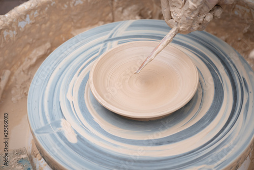 Clay plate rotating on the pottery wheel