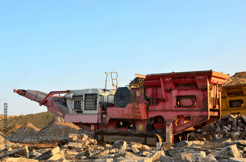 Mobile Stone crusher machine by the construction site or mining quarry for crushing old concrete slabs into gravel and subsequent cement production