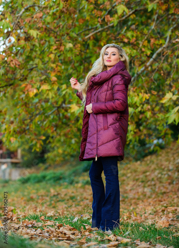 Professional stylist advice. Girl fashionable blonde walk in autumn park. Woman wear warm jacket. Jackets everyone should have. Best puffer coat to buy. How pick puffer jacket. Puffer fashion concept