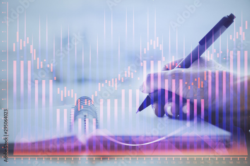 Forex graph on hand taking notes background. Concept of research. Multi exposure © peshkova