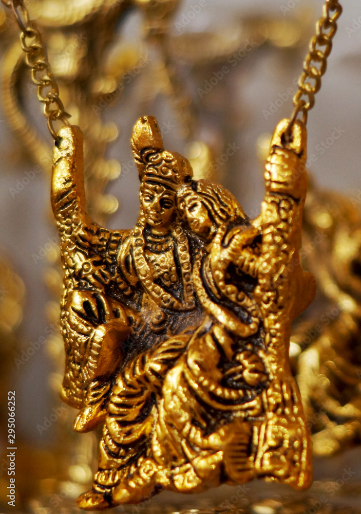 Closeup view of Bronze metallic Hindu god Krishna and radha figurine in display of a shop   