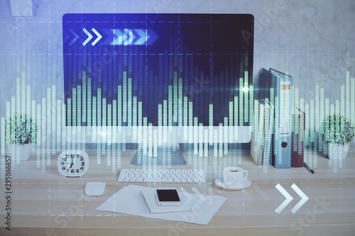 Forex graph hologram on table with computer background. Double exposure. Concept of financial markets.