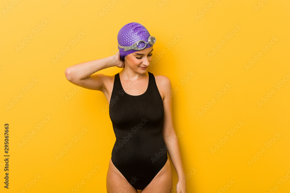 Young swimmer caucasian woman suffering neck pain due to sedentary lifestyle. Young swimmer caucasian woman suffering neck pain due to sedentary lifestyle.