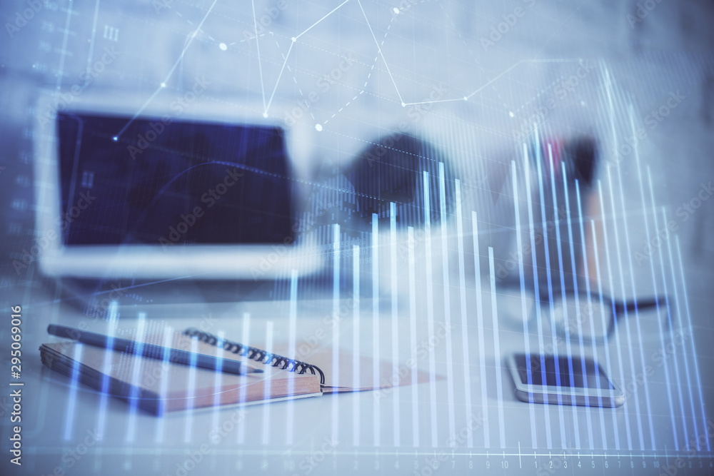 Forex graph hologram on table with computer background. Multi exposure. Concept of financial markets. Forex graph hologram on table with computer background. Multi exposure. Concept of financial markets.
