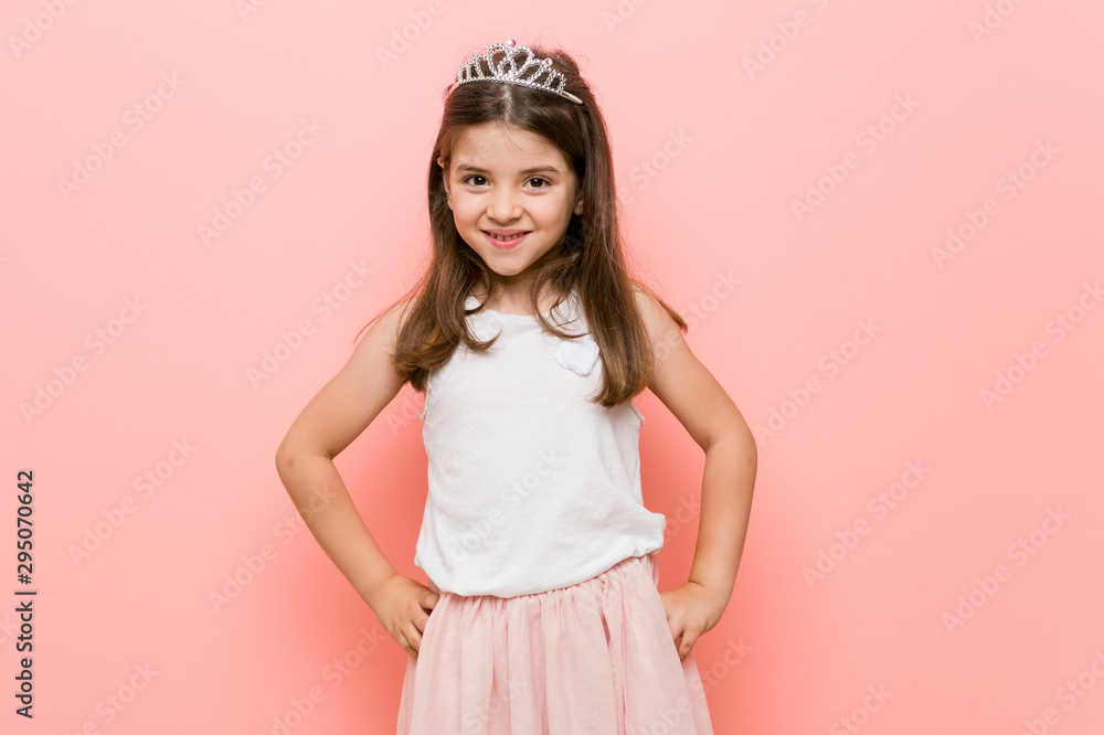 Little girl wearing a princess look confident keeping hands on hips. Little girl wearing a princess look confident keeping hands on hips.