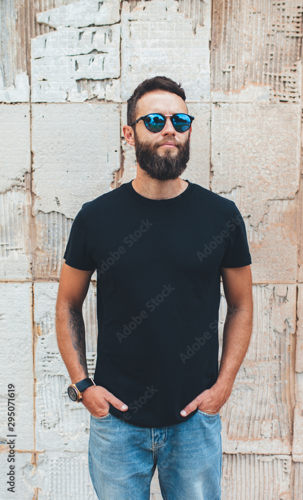 Handsome hipster man with beard wearing black blank t-shirt with space for your logo or design. black t shirt mockup. Handsome hipster man with beard wearing black blank t-shirt with space for your logo or design. black t shirt mockup.