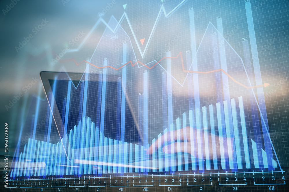 Double exposure of businessman's hands with laptop and stock market graph background. Concept of research and trading. Double exposure of businessman's hands with laptop and stock market graph background. Concept of research and trading.