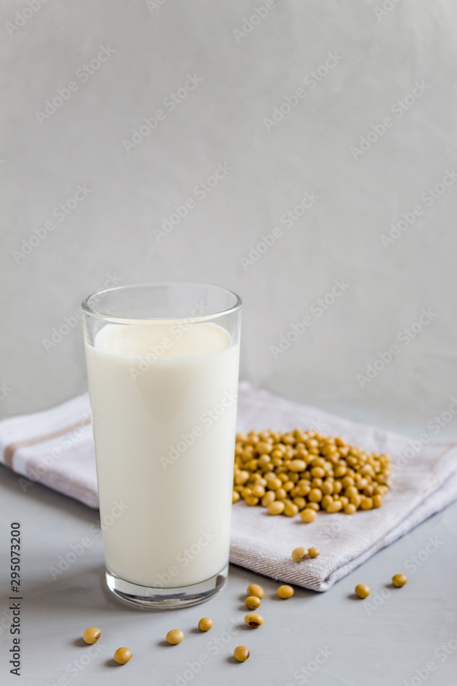Soy milk in a glass glass. Vegetarian food. Organic products, healthy food concept. Vertical orientation, side view, copy space. Soy milk in a glass glass. Vegetarian food. Organic products, healthy food concept. Vertical orientation, side view, copy space.