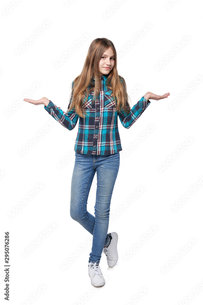 Teen girl in checkered shirt shrugging her shoulders Teen girl in checkered shirt shrugging her shoulders