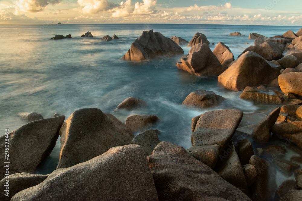 Rocky coast on la digue island with sunset Rocky coast on la digue island with sunset