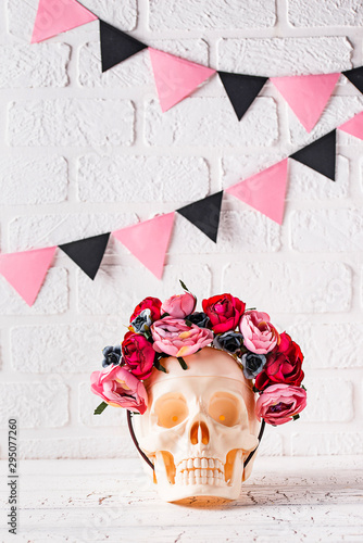 Skull with wreath of pink flowers