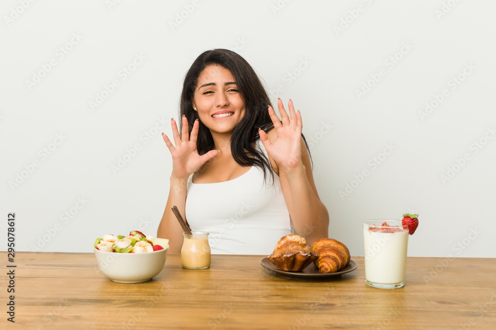 Young curvy woman taking a breakfast rejecting someone showing a gesture of disgust. Young curvy woman taking a breakfast rejecting someone showing a gesture of disgust.